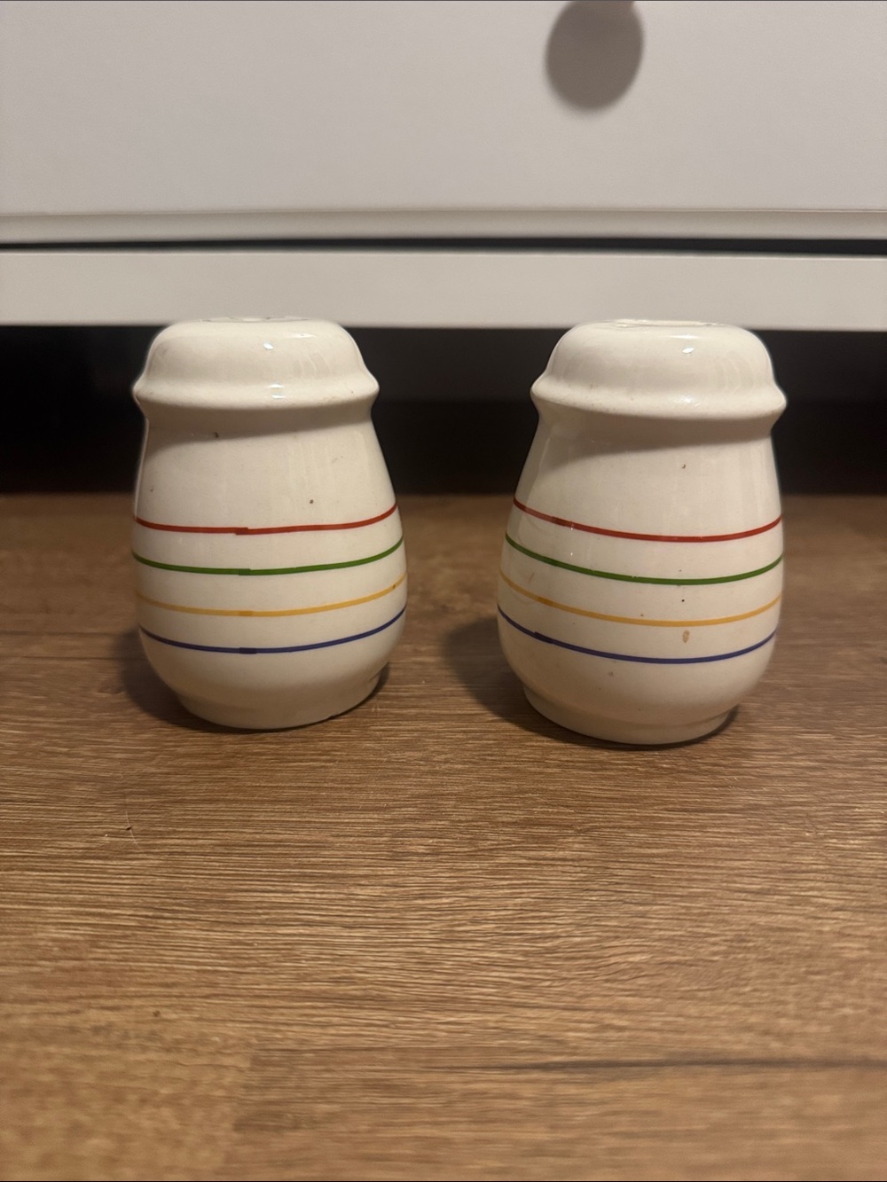 Cream Ceramic Salt and Pepper Shakers with Multicolor Stripe Accent
